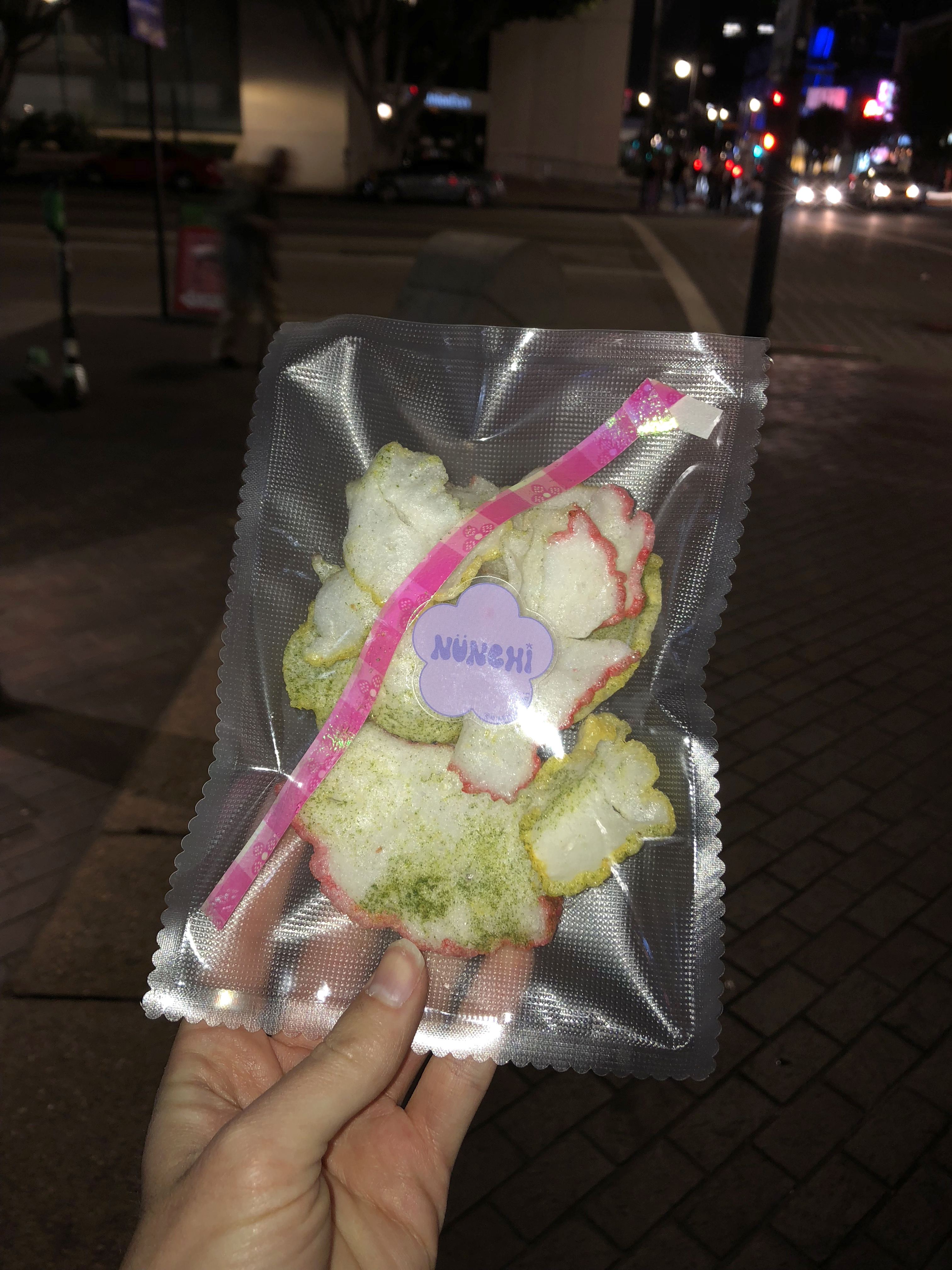 A pouch of dried snacks in someones hand